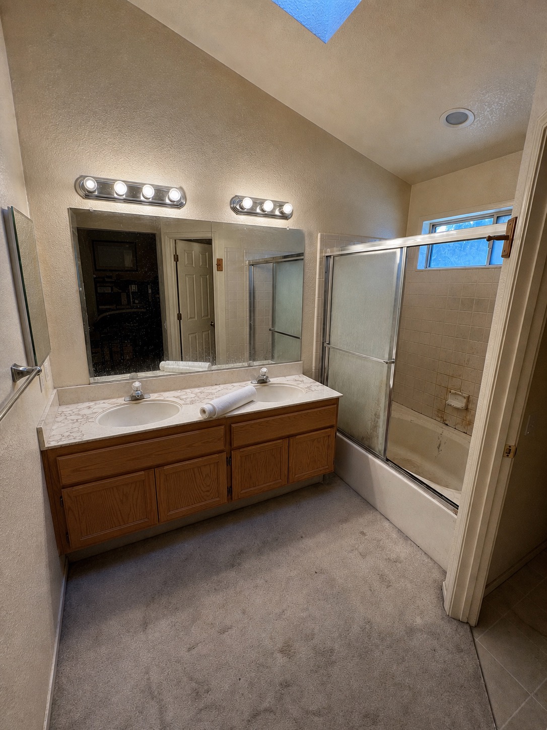 Primary bathroom before renovation, perspective-aligned with the finished room
