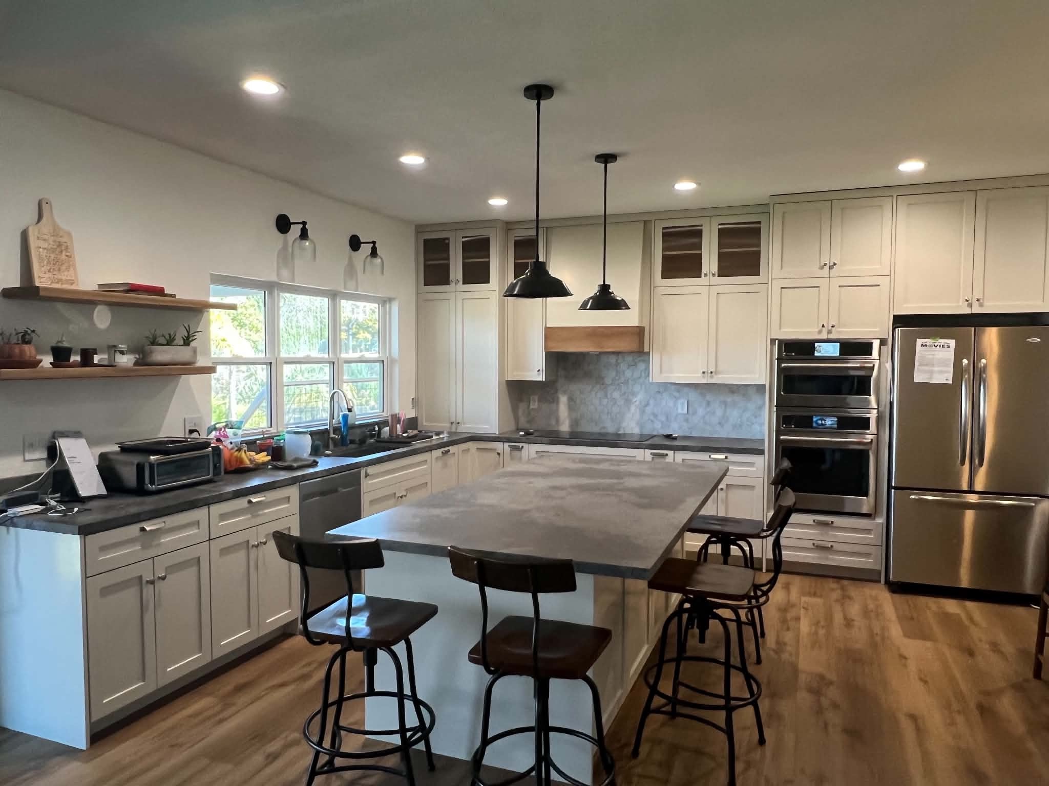 Large white shaker kitchen with full-height cabinetry and central island