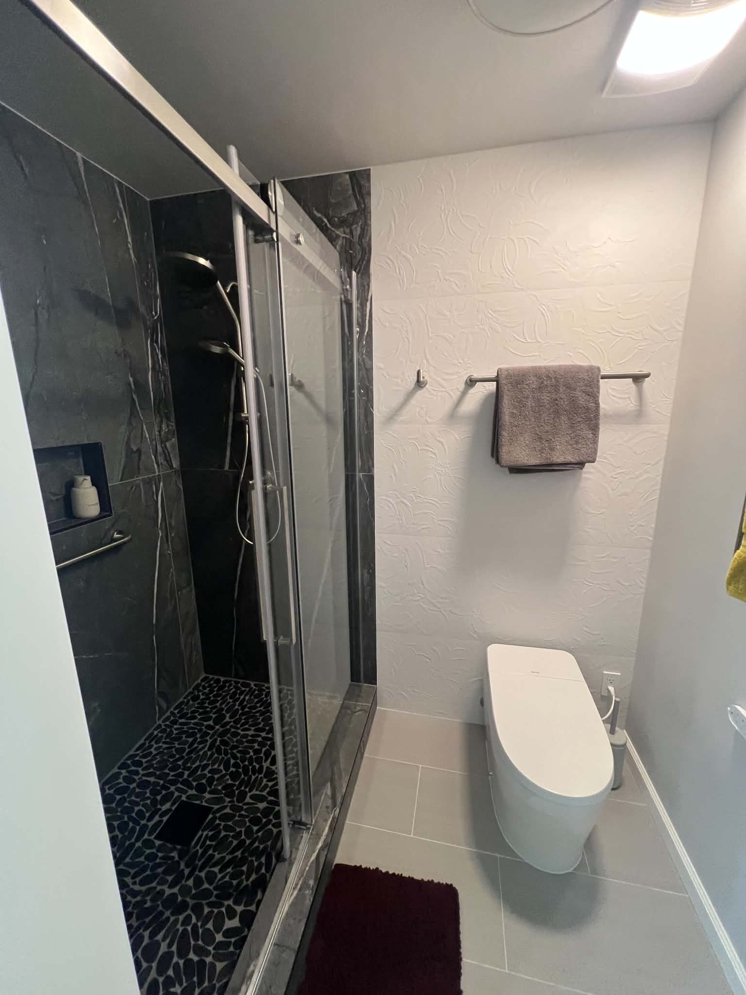 Accessible roll-in shower with brass fixtures and grab bars