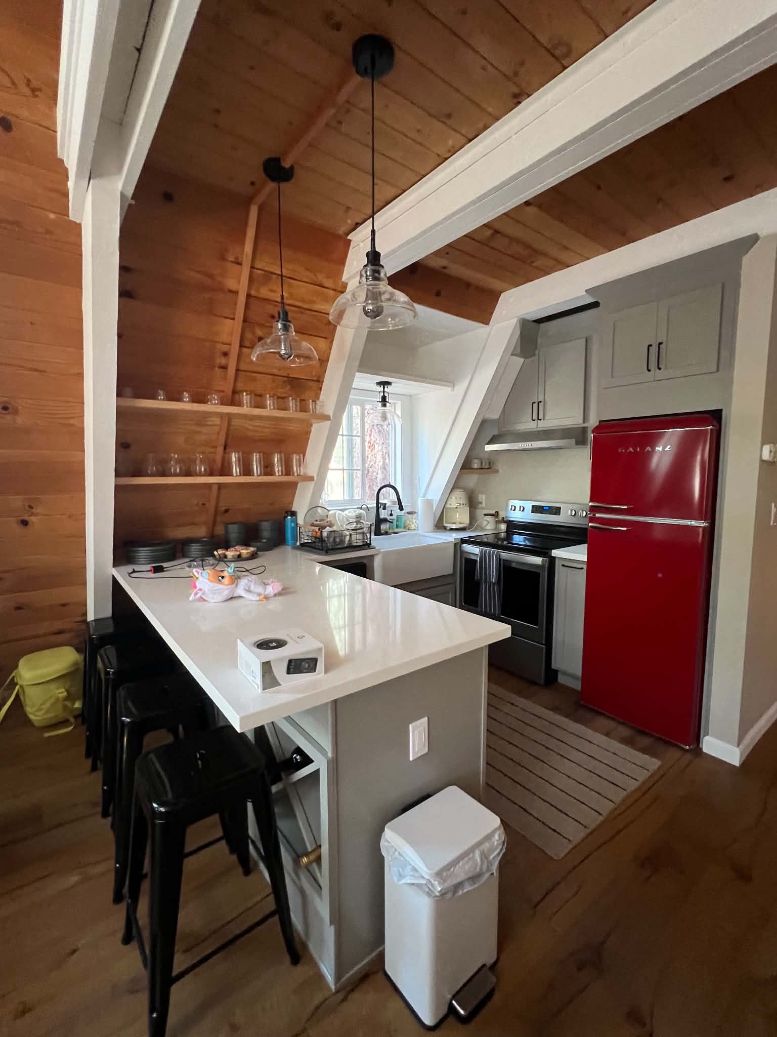 A-frame cabin kitchen remodel with white cabinetry