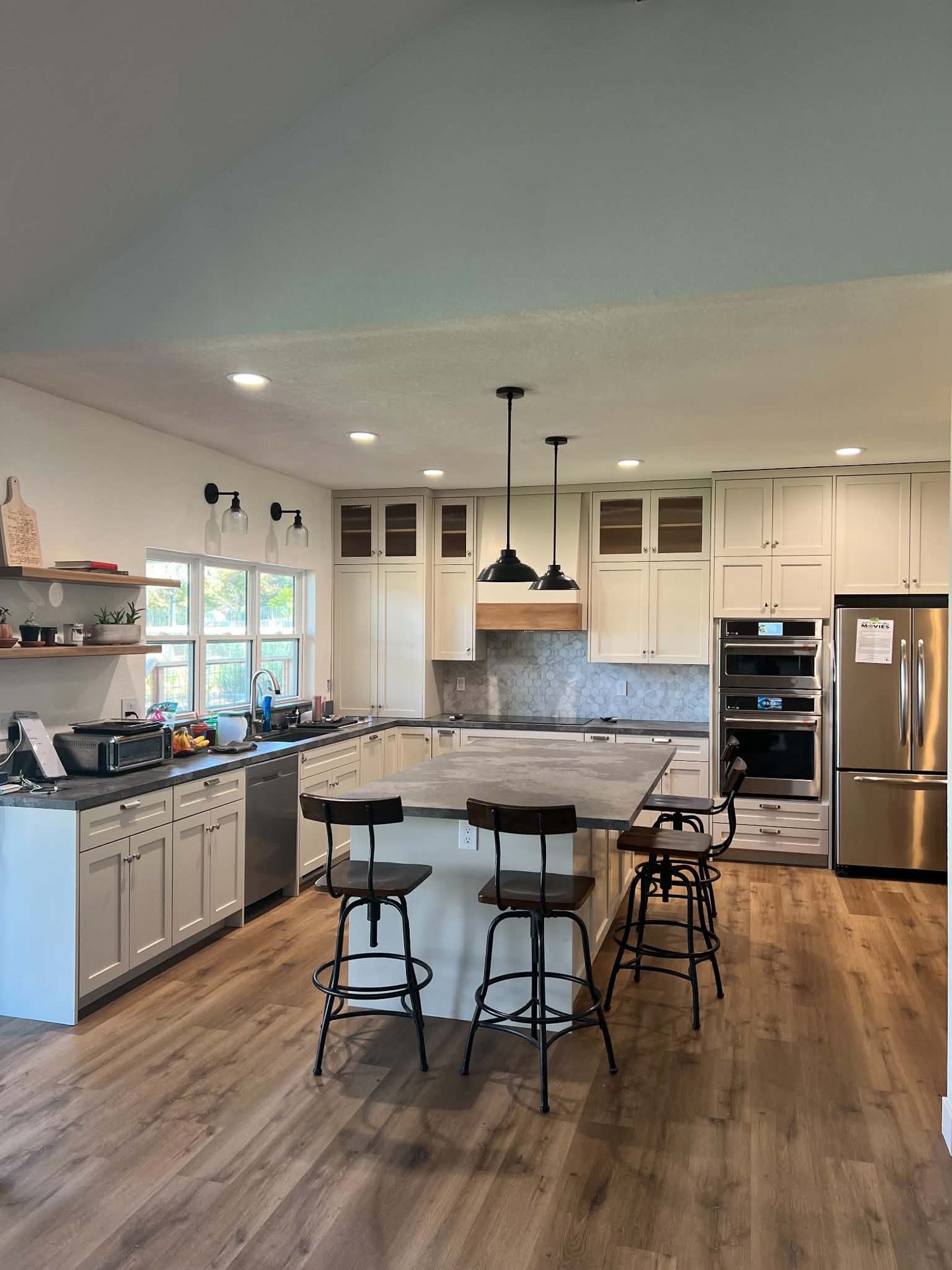Cream kitchen with glass-front uppers and dual wall ovens