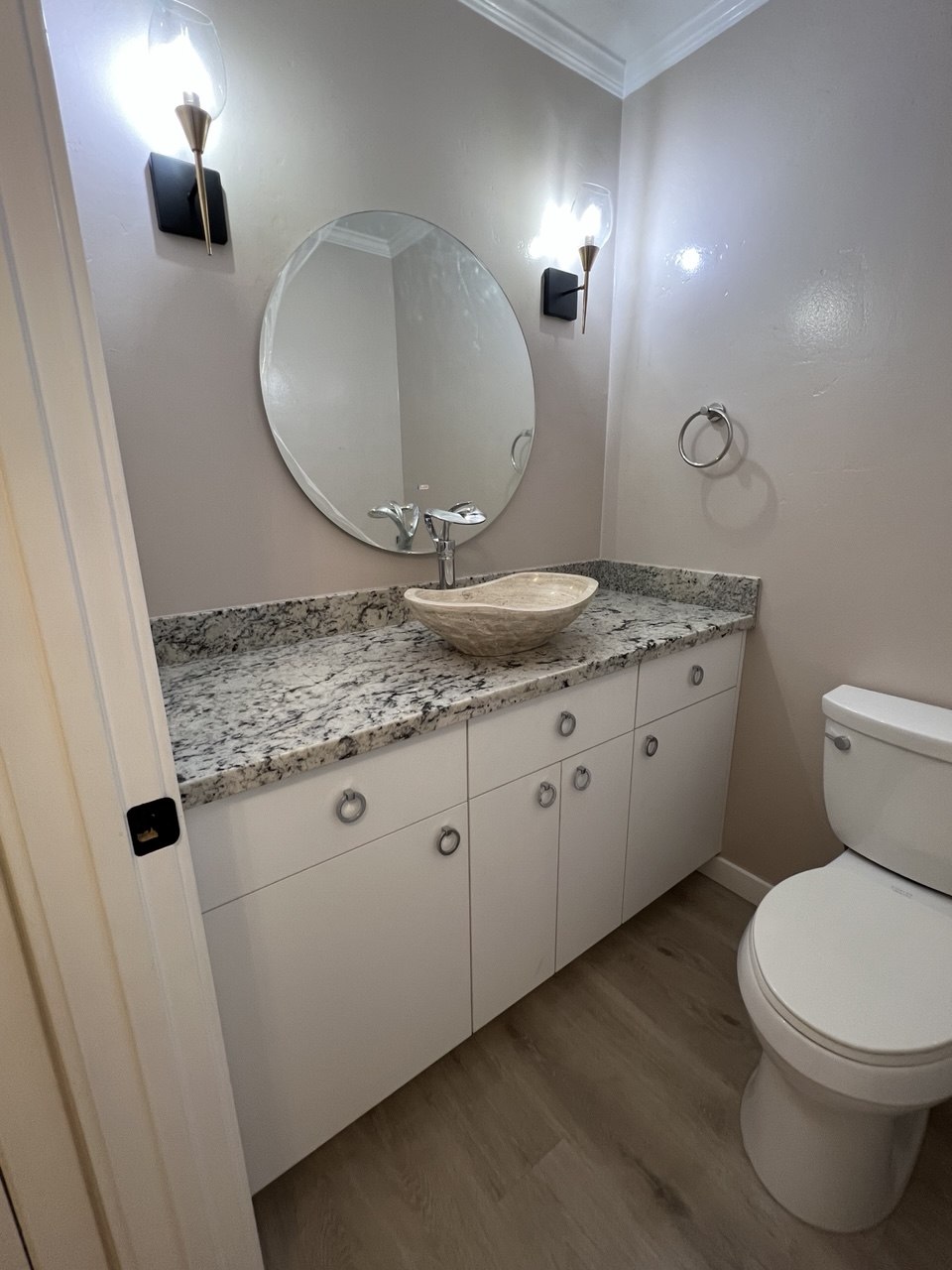 Powder room with vessel sink and patterned tile floor