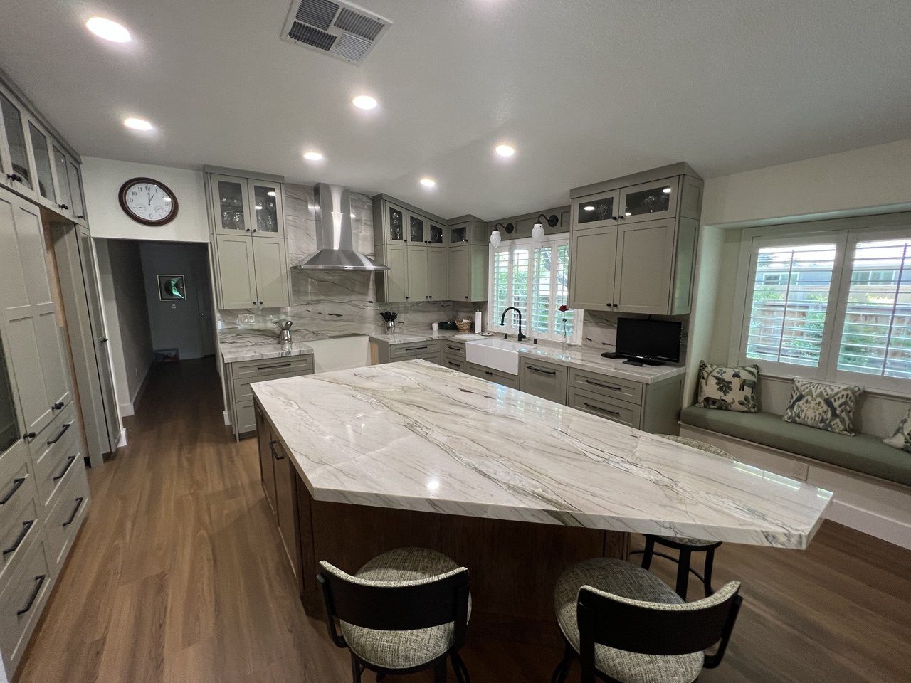 Sage green custom kitchen with marble waterfall island